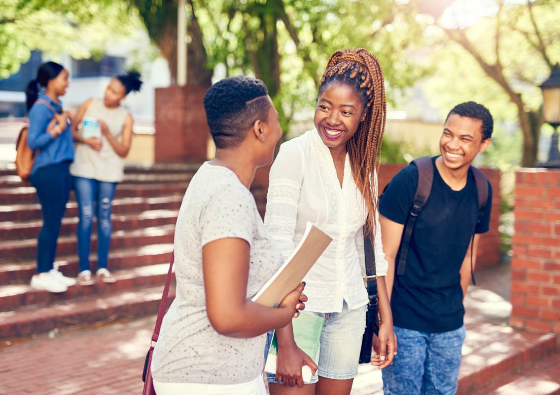 photo of teens talking at college campus