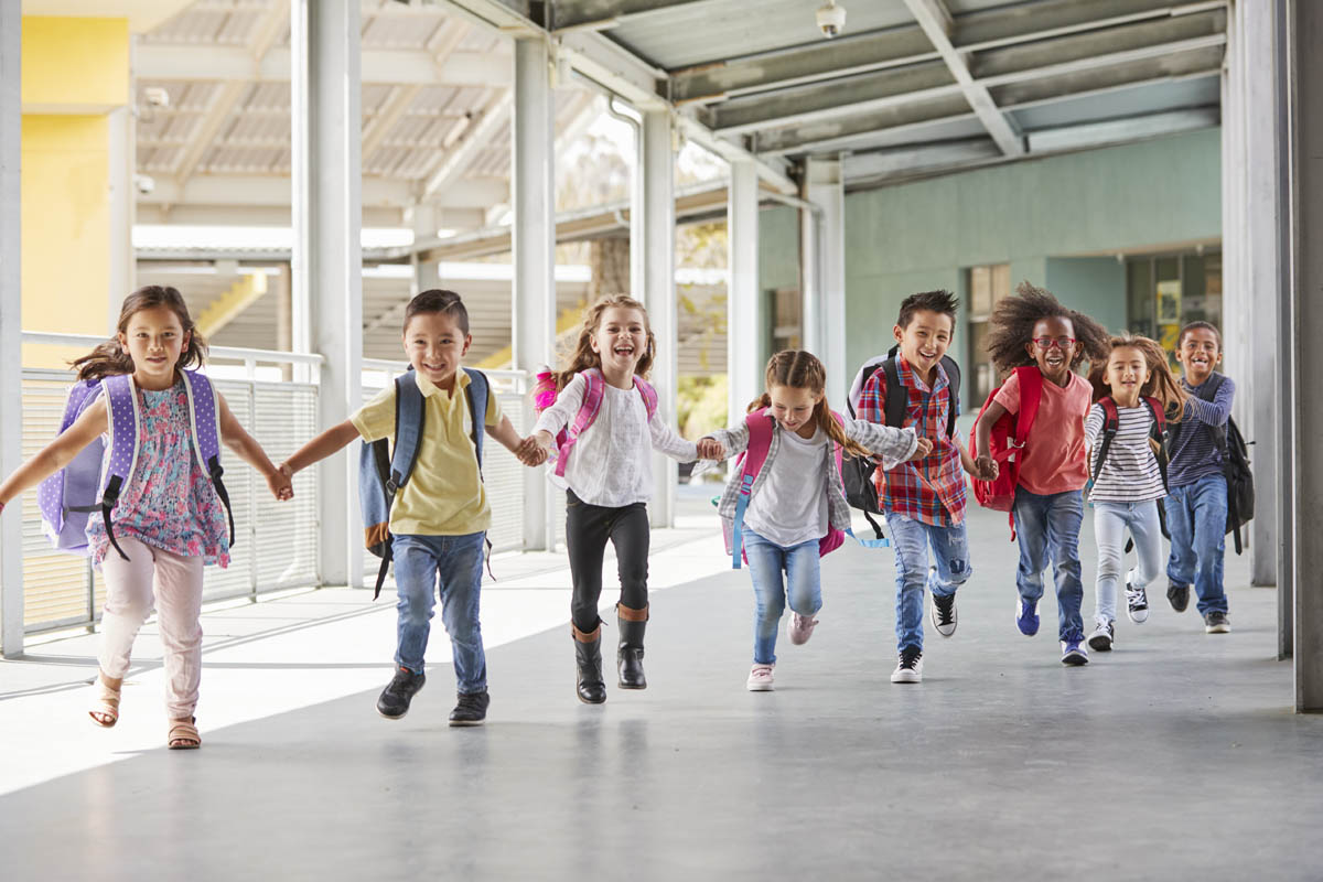 Photo of kids running in hallway at school